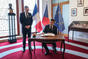 French President Emmanuel Macron signs a commemorative book at the Strak Academy, 5 March 2024.
