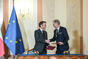 Czech Prime Minister Petr Fiala and French President Emmanuel Macron exchange signed documents, 5 March 2024.